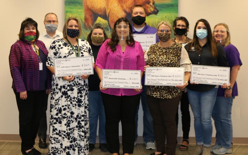 From left: LCM Superintendent Stacey Brister; LCI Principal Michael Ridout; Samantha Arrington; International Paper Representative Michelle Hatcher; Sommer Reynolds; Adam Strandberg; LCE Principal Kayla Casey; MMS Principal Kim Cox; International Paper Representative Stacey Nichols; and MVE Principal Carie Broussard. (Not pictured: Deidre Windham)
