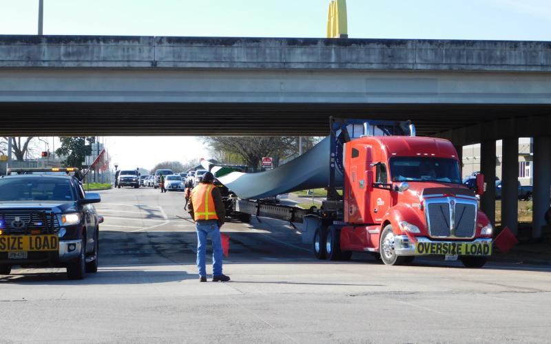 A truck tractor pulls a wind turbine blade coming from the Port of Beaumont.