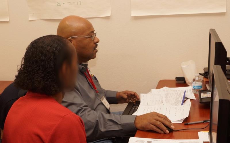 Dan Williams, a retired Entergy employee, assists a taxpayer as part of the VITA program.