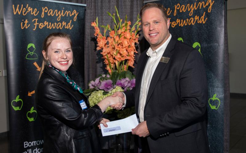 Education First FCU CEO Kevin Conn (R) presents a donation to Katherine Westerkamp (L) of BISD's Taylor Career Center to benefit school programs and students at the campus.