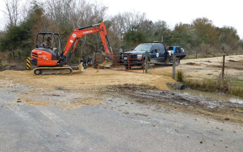 DD6 workers finishing a road built in exchange for easement.