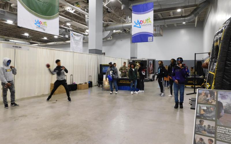 Branches of the armed services test physical prowess with pull-ups, football toss