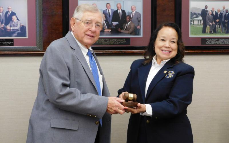 Pat Anderson accepts the presidential mantle, and gavel, from outgoing Port of Beaumont Board of Commissioners President Georgine Guillory.