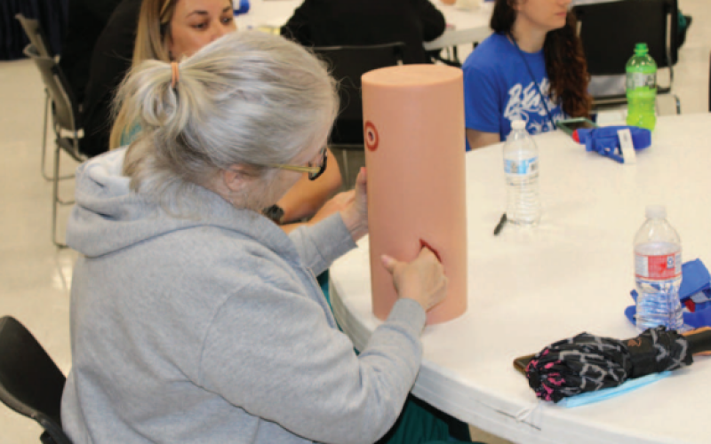 Participants practicing emergency closure techniques