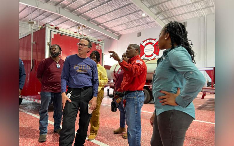 Teachers learning about various types of emergency response equipment with Terry Matthews, Emergency Response and Security Department Lead.