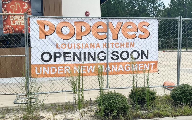 Banner hanging on fence at Popeyes Lumberton location. Photo by Dannie Oliveaux
