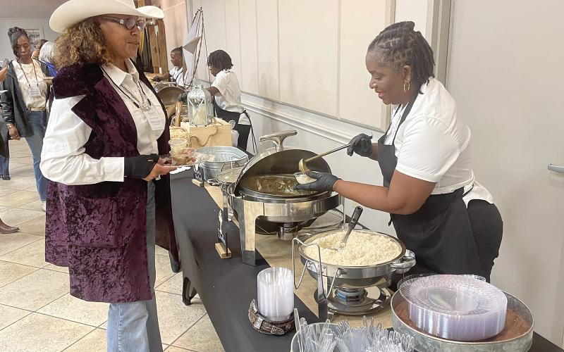A food vendor serves one of the many guests at the 34th annual Hall of Fame event. Photo by Dannie Oliveaux