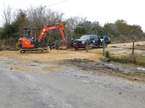 DD6 workers finishing a road built in exchange for easement.