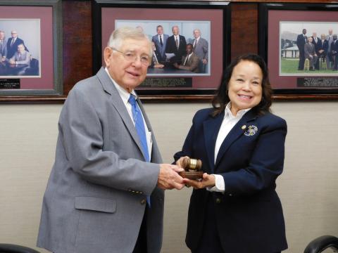 Pat Anderson accepts the presidential mantle, and gavel, from outgoing Port of Beaumont Board of Commissioners President Georgine Guillory.