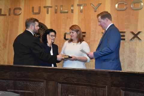 Kathleen Jackson takes her oath of office as son Tommy Jackson and daughter Thea Etlinger watch. Chairman Peter Lake administers the oath.