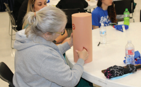 Participants practicing emergency closure techniques