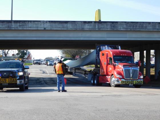 A truck tractor pulls a wind turbine blade coming from the Port of Beaumont.