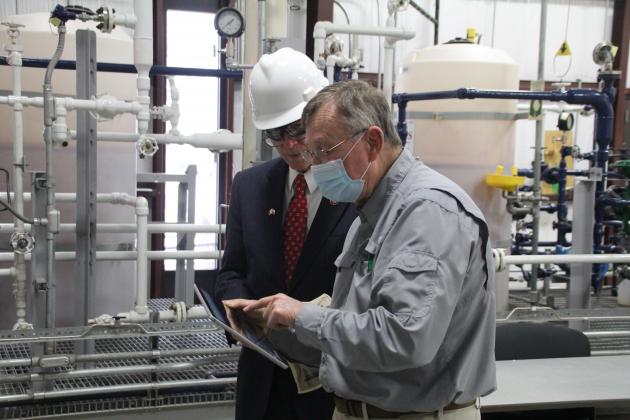 Process technology/instrumentation director Earl Geis shows Congressman Brian Babin around the facility.