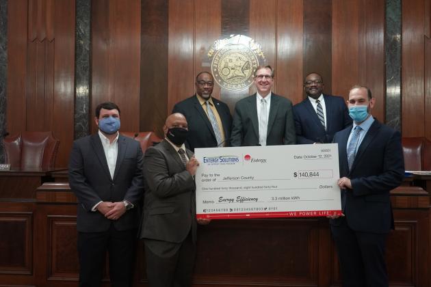 Pictured (bottom, L-R): Blake Flowers, Entergy Texas region customer service manager; Ron Fletcher, Entergy Texas customer service manager; Mark Delavan, Entergy Solutions program manager (top L-R) Commissioner Michael Sinegal; Judge Jeff Branick; and Commissioner Everette “Bo” Alfred