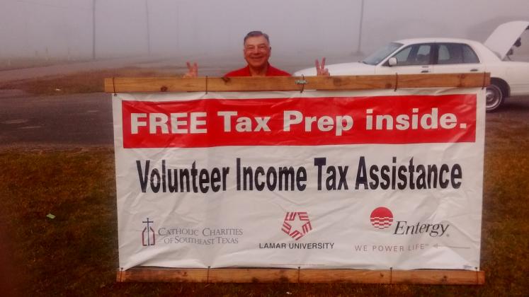 A banner like this, held by Jon Korejwa, marks the location for tax training and assistance.