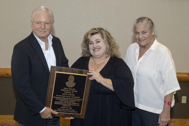 Kathi Hughes accepts her award from Bob Phillips with Phillips Entertainment and Joan Henderson, Director of TX Dot Travel Information Division.