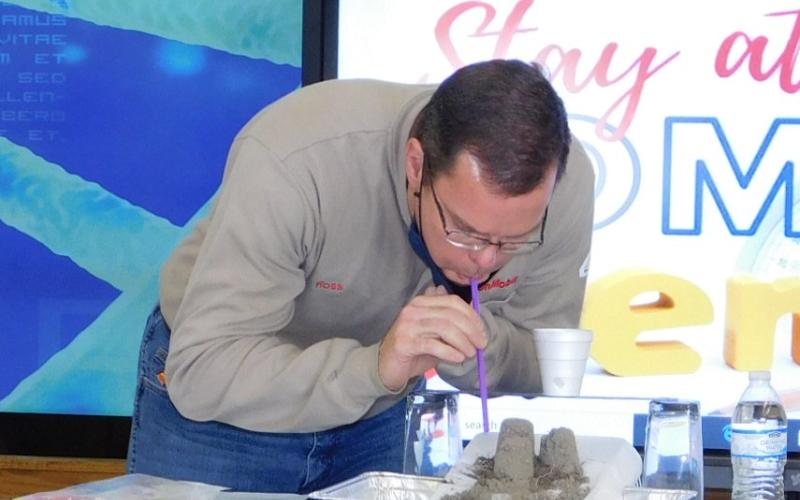 ExxonMobil Process Manager Ross Garner demonstrates wind erosion.