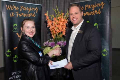 Education First FCU CEO Kevin Conn (R) presents a donation to Katherine Westerkamp (L) of BISD's Taylor Career Center to benefit school programs and students at the campus.