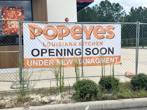 Banner hanging on fence at Popeyes Lumberton location. Photo by Dannie Oliveaux