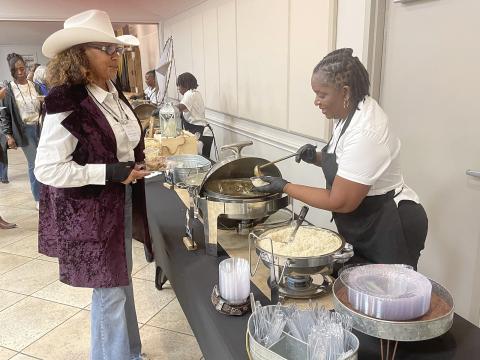 A food vendor serves one of the many guests at the 34th annual Hall of Fame event. Photo by Dannie Oliveaux
